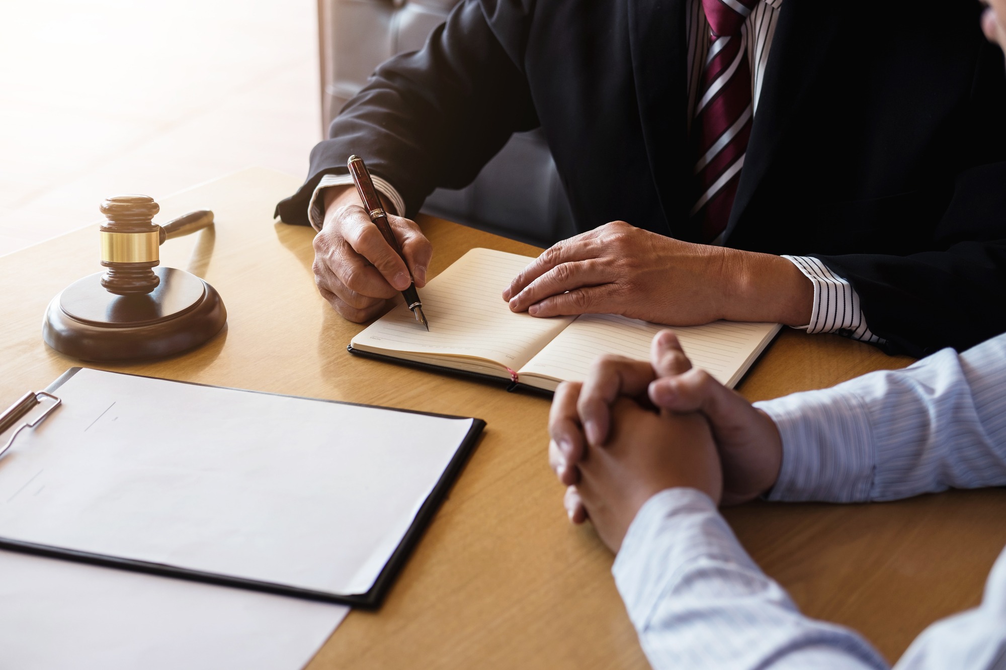 Close up of gavel, Male lawyer or judge Consult with client and working with Law